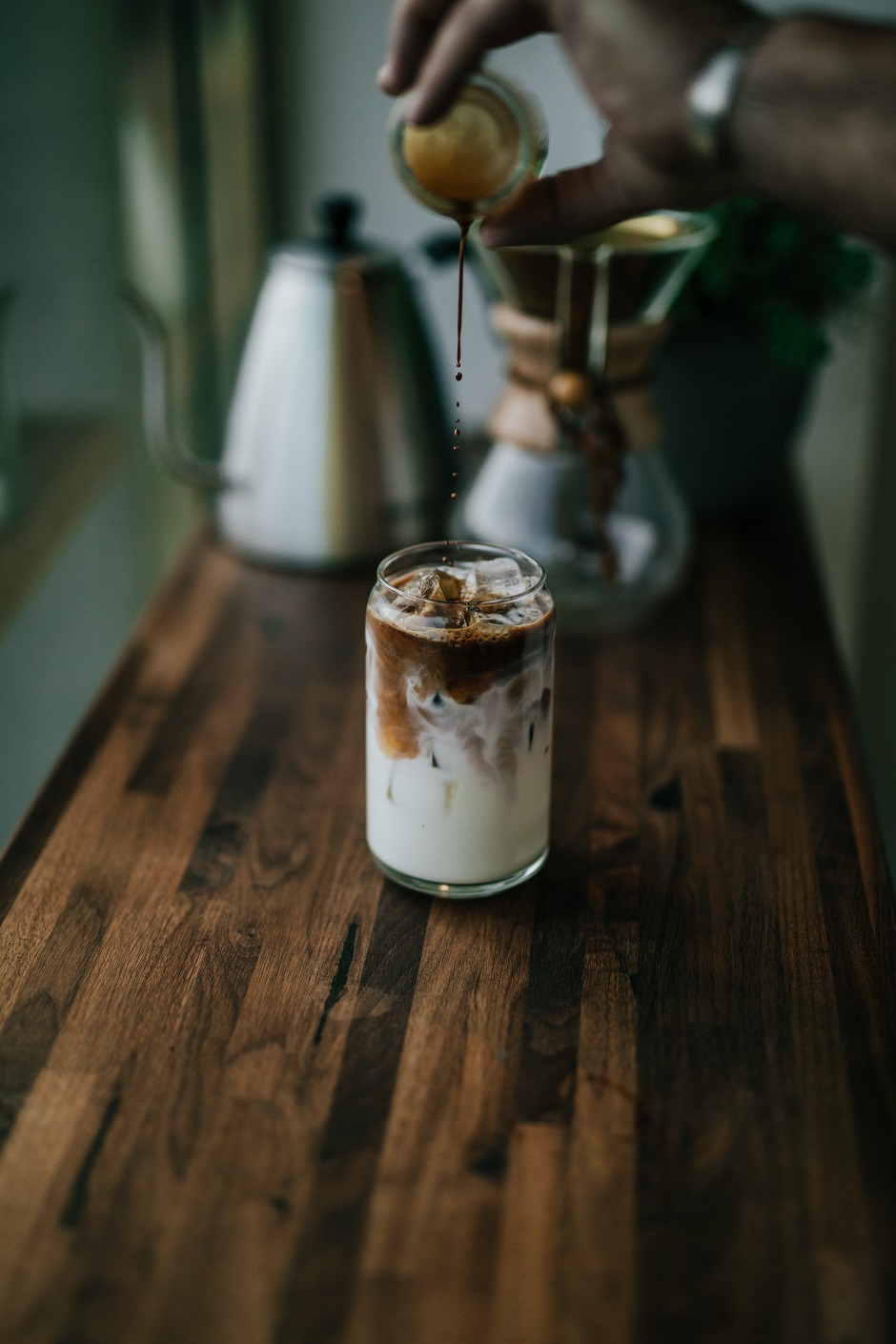 iced coffee with milk being poured