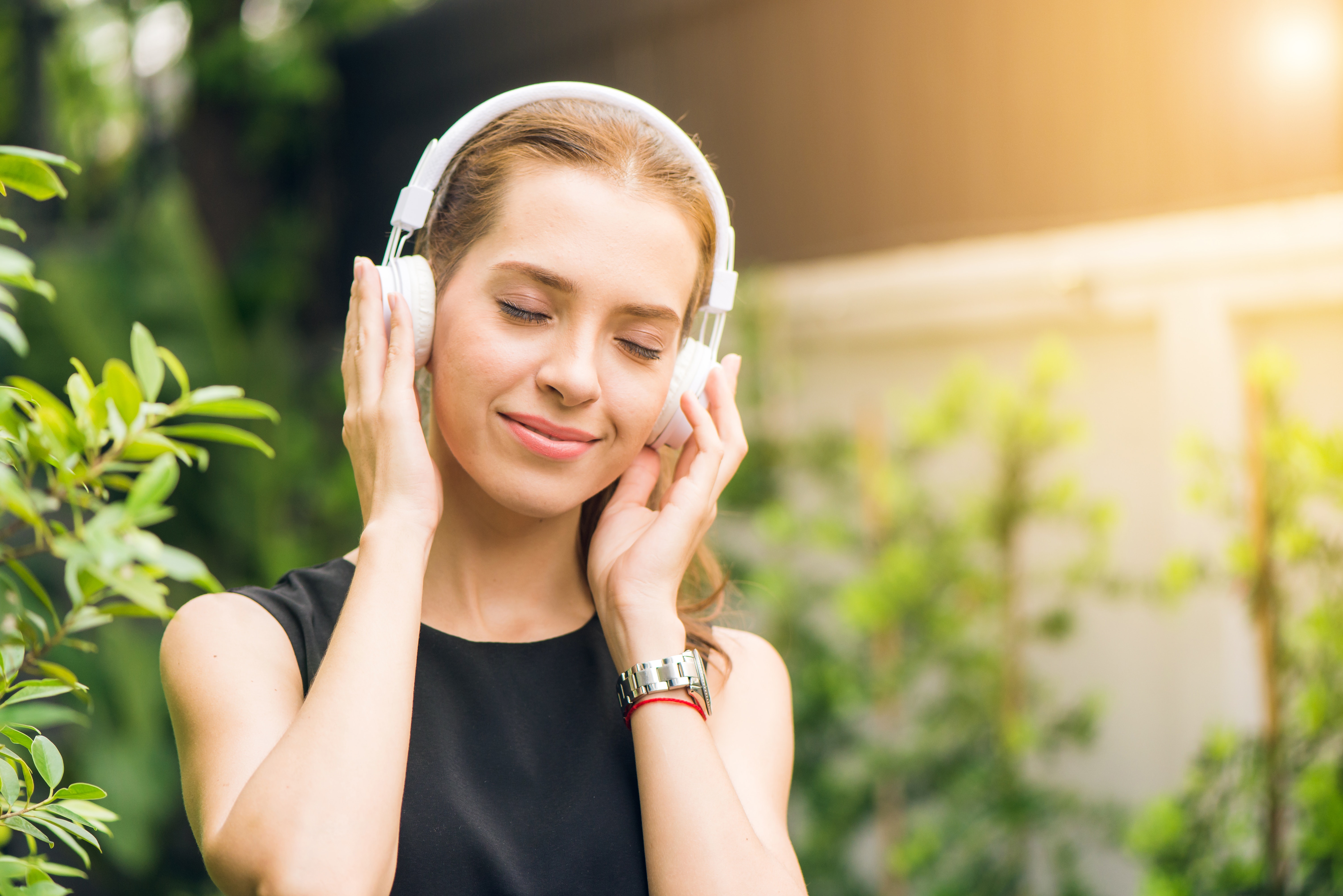 A woman wearing headphones listening to music 