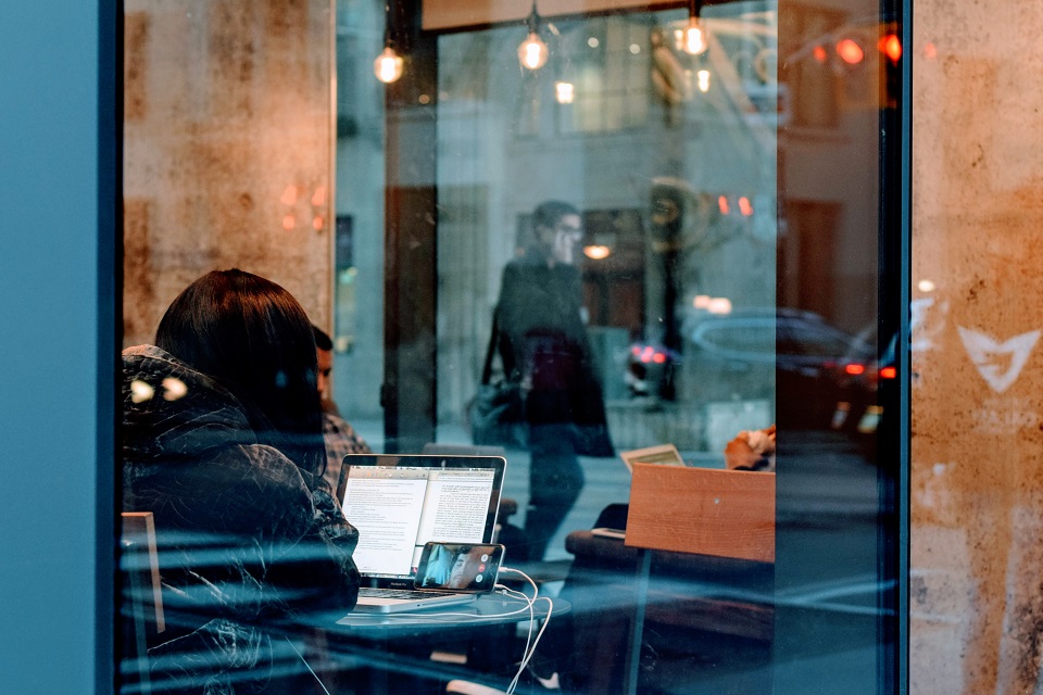 Woman using WiFi in a cafe