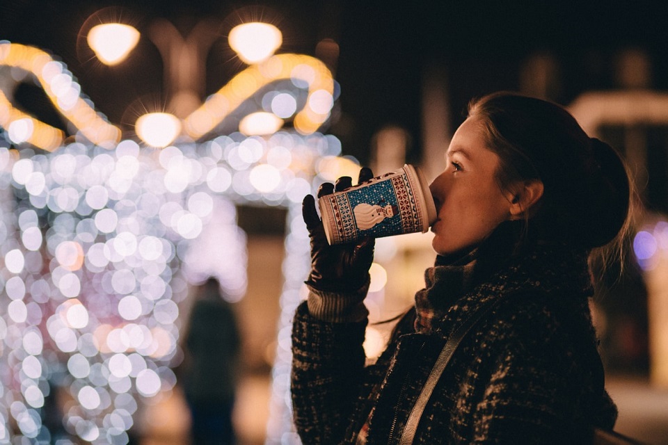 woman drinking a christmas coffee